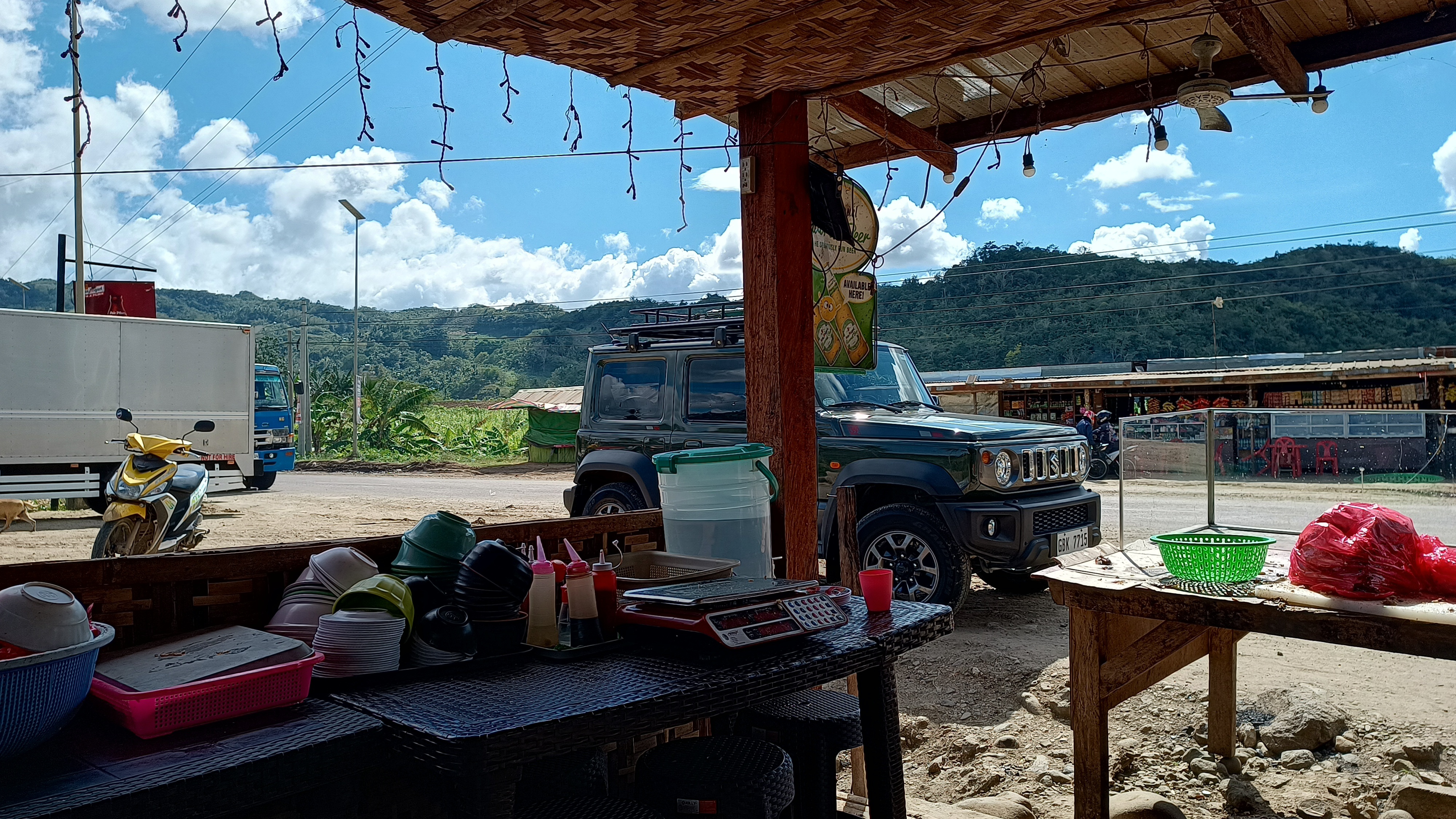 Roadside vendor stop with Jimny in background